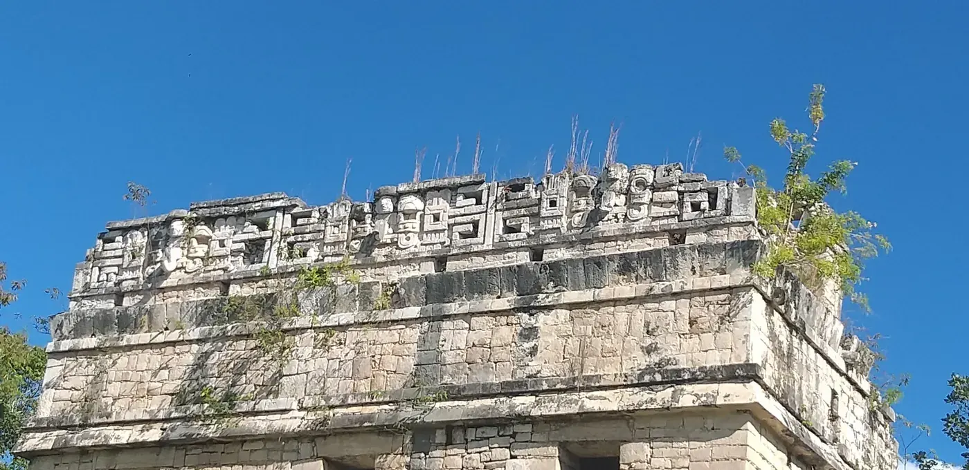 Ornate Maya building facade with carvings at Chichen Itza