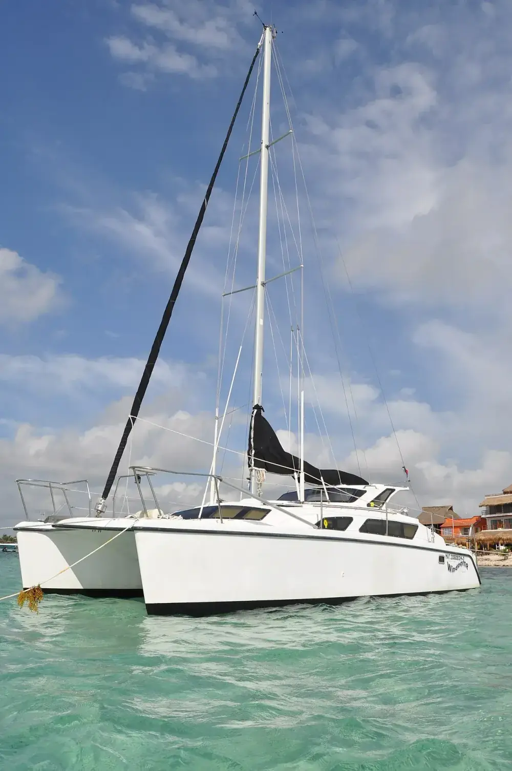 Private Catamaran Cancun — Riviera Maya Sailing Charter, Sunset & Snorkeling Private sailing catamaran on turquoise Caribbean water in Riviera Maya
